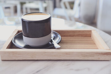Coffee Cup  on Wooden tray in coffee shop.