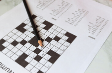 pencil and solves crossword puzzle