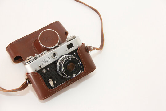Antalya, Turkey, March 222, 2023. Old  vintage Russian Soviet photo camera in a brown protective case on a white background