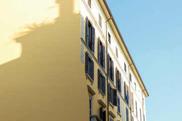 Yellow house building against a blue sky background