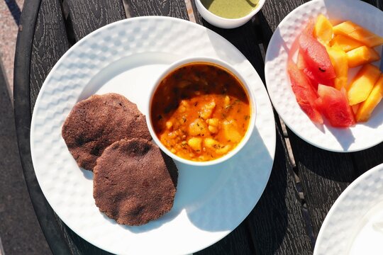 Indian fasting breakfast or lunch thali. Aloo ki sabzi or potato curry along with Sabudana Vada and Kuttu ki puri. Fried buckwheat bread. Served with fresh fruits. Copy space. Navratri, Mahashivratri 