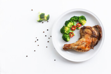 Healthy food grilled chicken has broccoli vegetable in plate on white wood table.