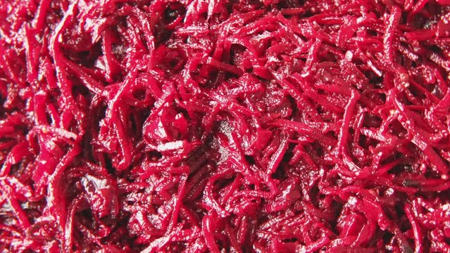 Beetroot salad with dressing and spices. Cooked chopped beet. Asian dish grated beets or beetroot and condiments, garlic, onion and pepper. Food background spinning. Copy space top view Full Frame