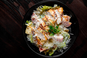 Caesar salad with croutons, cheese, eggs, tomatoes and grilled chicken