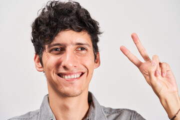 Young man with strabismus smiling positively at the camera.