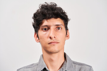 Obraz premium Young man with cataract in his eye looking seriously at the camera.