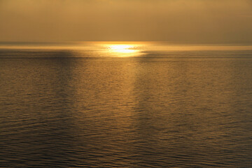 Fototapeta premium Landscape - the setting sun is reflected in the sea water