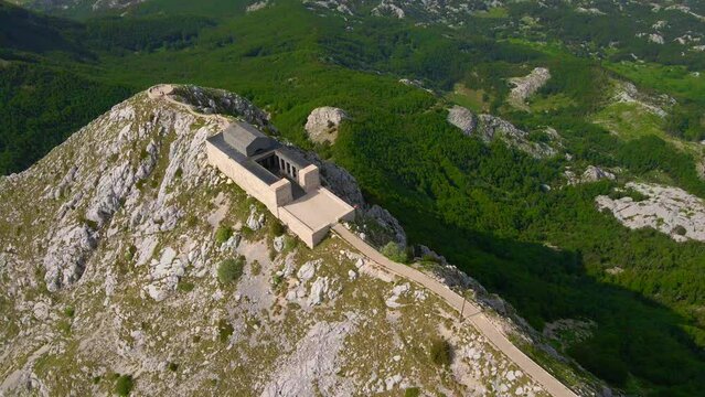 This stock video showcases the breathtaking aerial footage of the Njegos Mausoleum located at the top of the Jezerski peak in Montenegro. The mausoleum is a stunning architectural masterpiece
