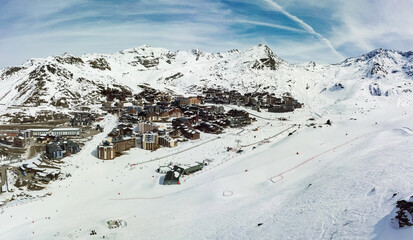 Fototapeta na wymiar Aerial view of the snowy Val Thorens ski resort in the French Alps in winter - Luxurious hotels secluded in a white valley in altitude among high peaks and ski slopes