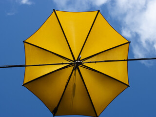 yellow umbrella against blue sky