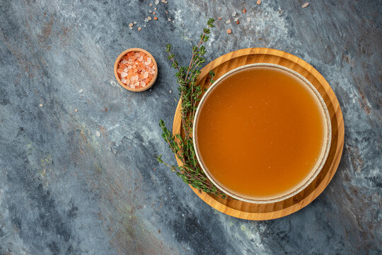 Bone meat chicken broth in a bowl on a dark background, banner, menu, recipe place for text, top view