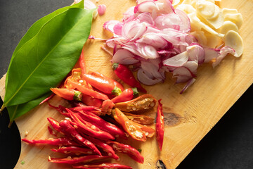 Sliced ​​hot red chilies and shallots on a chopping board
