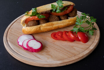 Black background .Swedish meatballs between bread