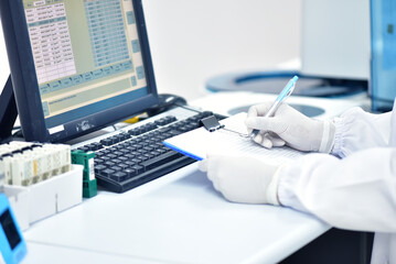 Female medical technologist taking notes in lab on lab tools background female chemist concept researcher medical