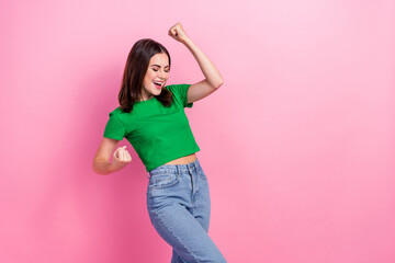 Photo of shiny pretty girl wear green crop top shouting rising fists empty space isolated pink...