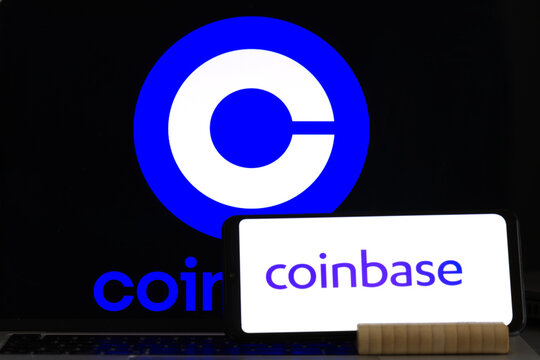 Smartphone with Coinbase logo on background of Coinbase symbol blurred on computer screen Business and technology. Exchange of cryptocurrencies, USA, March 23, 2023.