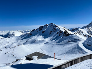 Snowy mountains in Switzerland. Panoramic view over the mountains during winter. Ski area Arosa,...