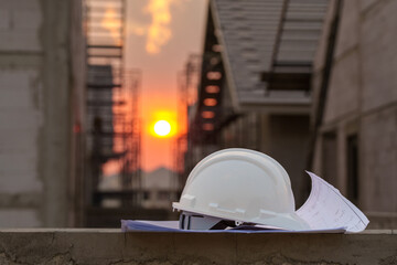 white safety helmet in construction site and construction site worker background