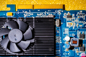 A computer board with a cooler on a colored background.