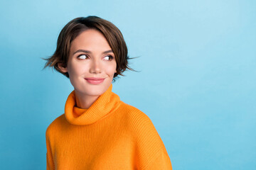 Photo of satisfied adorable lady look interested empty space advert isolated on blue color background