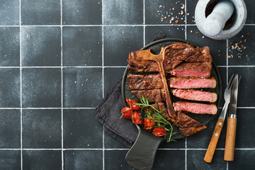 Steaks T-bone. Sliced beef grilled T-bone or porterhouse meat steak with spices rosemary and pepper...
