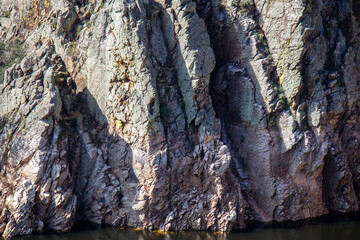 Part of the rocky mass called "Salto del Gitano". In the center of the photograph, a nest with black storks. Monfrag&uuml;e National Park, C&aacute;ceres, Spain