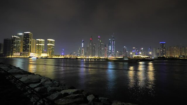 4K night time lapse video with Dubai skyscraper modern office skyline. Long exposure night video in Dubai marina.