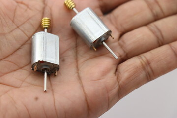Double shaft dc motors held in hand with metal gear attached to its rotating shaft