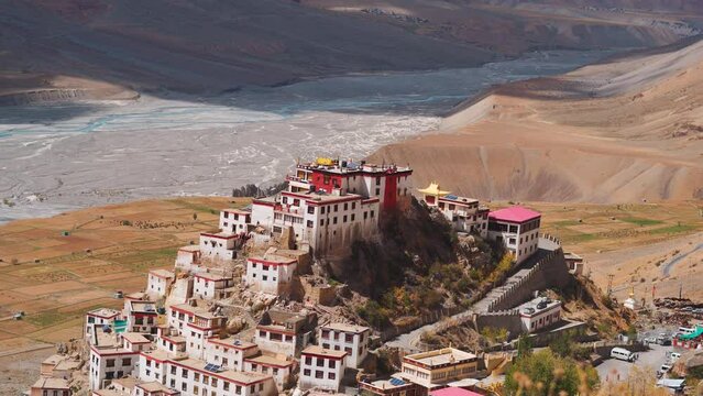 4K high angle shot of the Key monastery from the mountain besides it at Kaza in Spiti Valley, Himachal Pradesh, India. Key gompa in front of the river during the sunny day, Monastery background.	