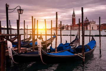 Obraz na płótnie Canvas Gondolas in Venice on sunset next to San Marco square. Famous landmark in Italy