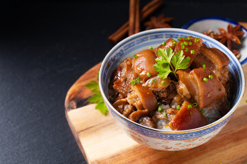 Food concept Spot focus Homemade Asian 5 spice  braised pork and rice on black background with copy...