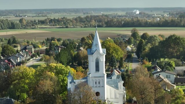 Drone shot over The Saint Anne Church in Bar with wood trees and houses in Ukraine