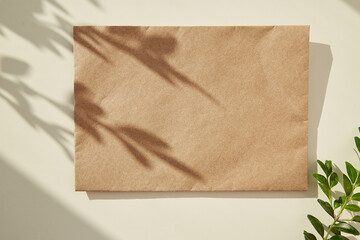 Mock up of craft envelope under shadow. Copy space - obrazy, fototapety, plakaty