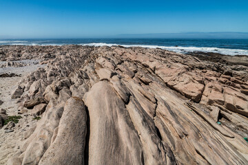 Tranquil atlantic sea shore in South Africa, Northern Cape, with rocks on a sunny day with blue...