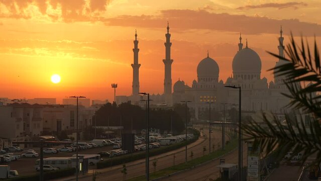 Silhouette of Sheikh Zayed Grand Mosque landmark building in Abu Dhabi during a beautiful sunrise sky. Travel to United Arab Emirates.  4k video