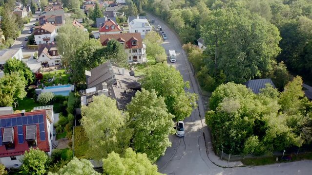 Beautiful view of buildings with green trees and road in the city of Munich, Germany