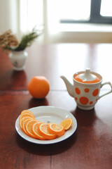 Modern still life with citrus fruits, orange juice and sliced oranges on kitchen table, detox diet concept, summer vitamin drinks