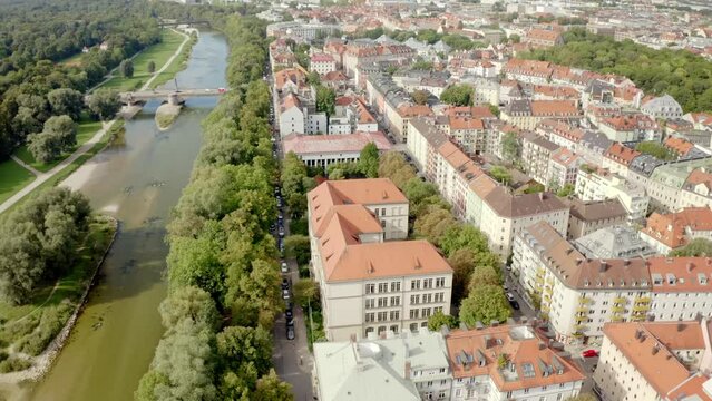 Beautiful view of buildings and bridge with cars over the river in the city of Munich, Germany