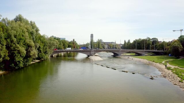 Beautiful view of a bridge with cars over the river in the city of Munich, Germany