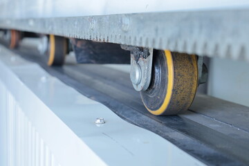 sliding door rubber wheel. Closeup of old rubber caster wheel for movement of barn door or wall...