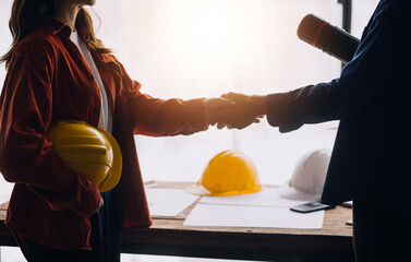 Construction and structure concept of engineer working drawing on blueprint meeting for project working with partner on model building and engineering tools in working site, construction concept