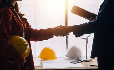 Construction and structure concept of engineer working drawing on blueprint meeting for project working with partner on model building and engineering tools in working site, construction concept