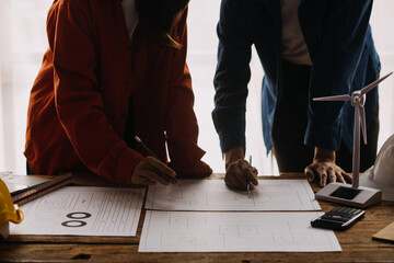 Construction and structure concept of engineer working drawing on blueprint meeting for project working with partner on model building and engineering tools in working site, construction concept