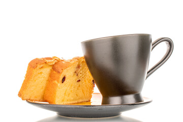 Two pieces of aromatic homemade raisin cake with black ceramic cup on saucer, macro, isolated on white background.