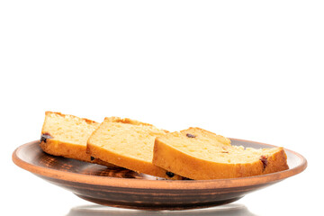 Three pieces of fragrant homemade muffin with raisins on a clay dish, macro, isolated on white background.