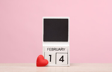 Valentine's Day. Block calendar with the date February 14 on pink background with heart. Love romantic concept