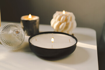 Burning candles on table indoors. Cozy home interior decor