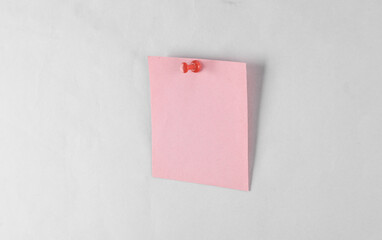 Pink square memo paper pinned on gray background