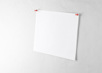 White blank sheet of paper ads pinned on a gray background