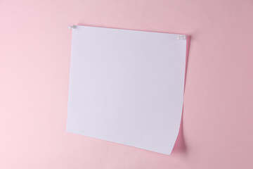 Obraz na płótnie Canvas White blank sheet of paper ads pinned on pink background